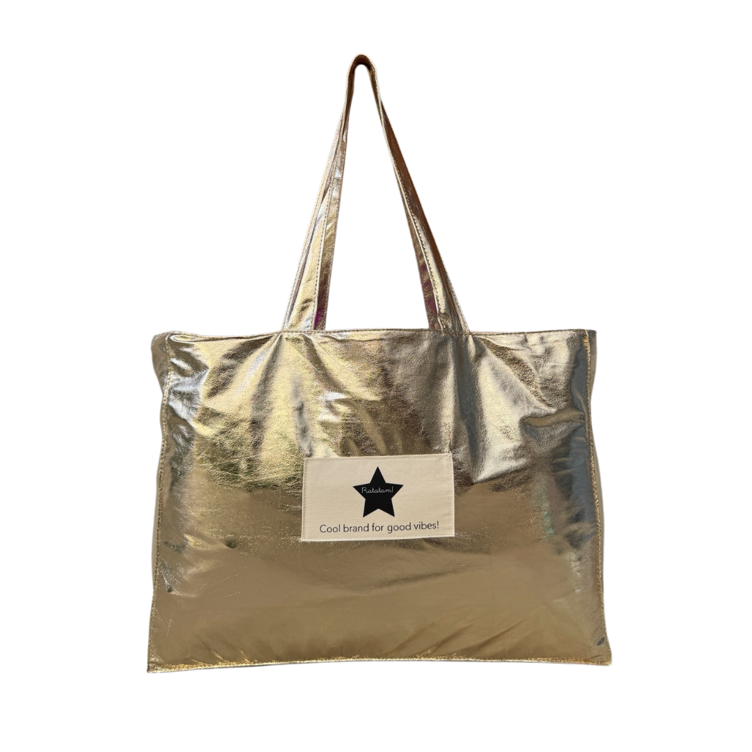 Gold metallic tote bag with a visible brand label on a white background