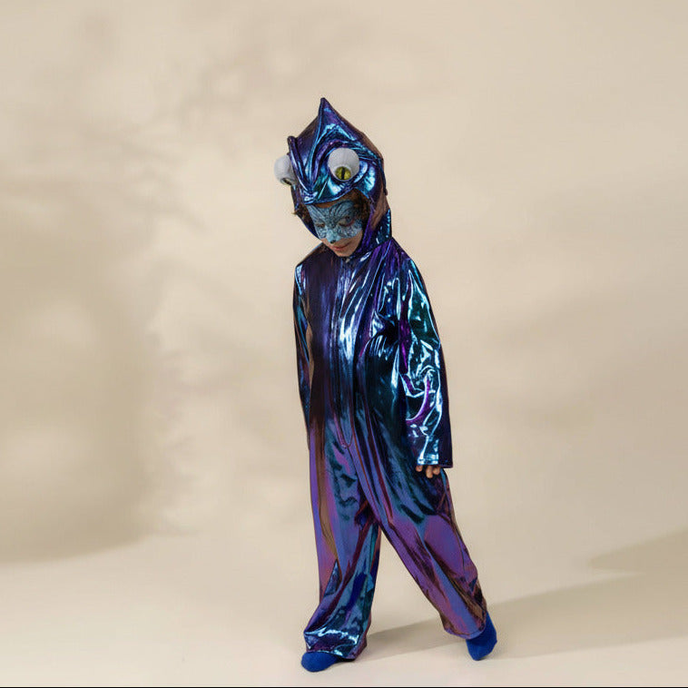 Child wearing a blue and purple costume with a mask on a beige background