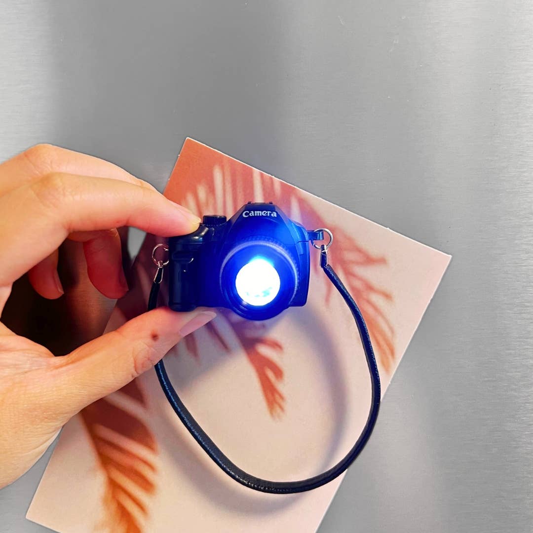 Blue camera-shaped light on a gray background