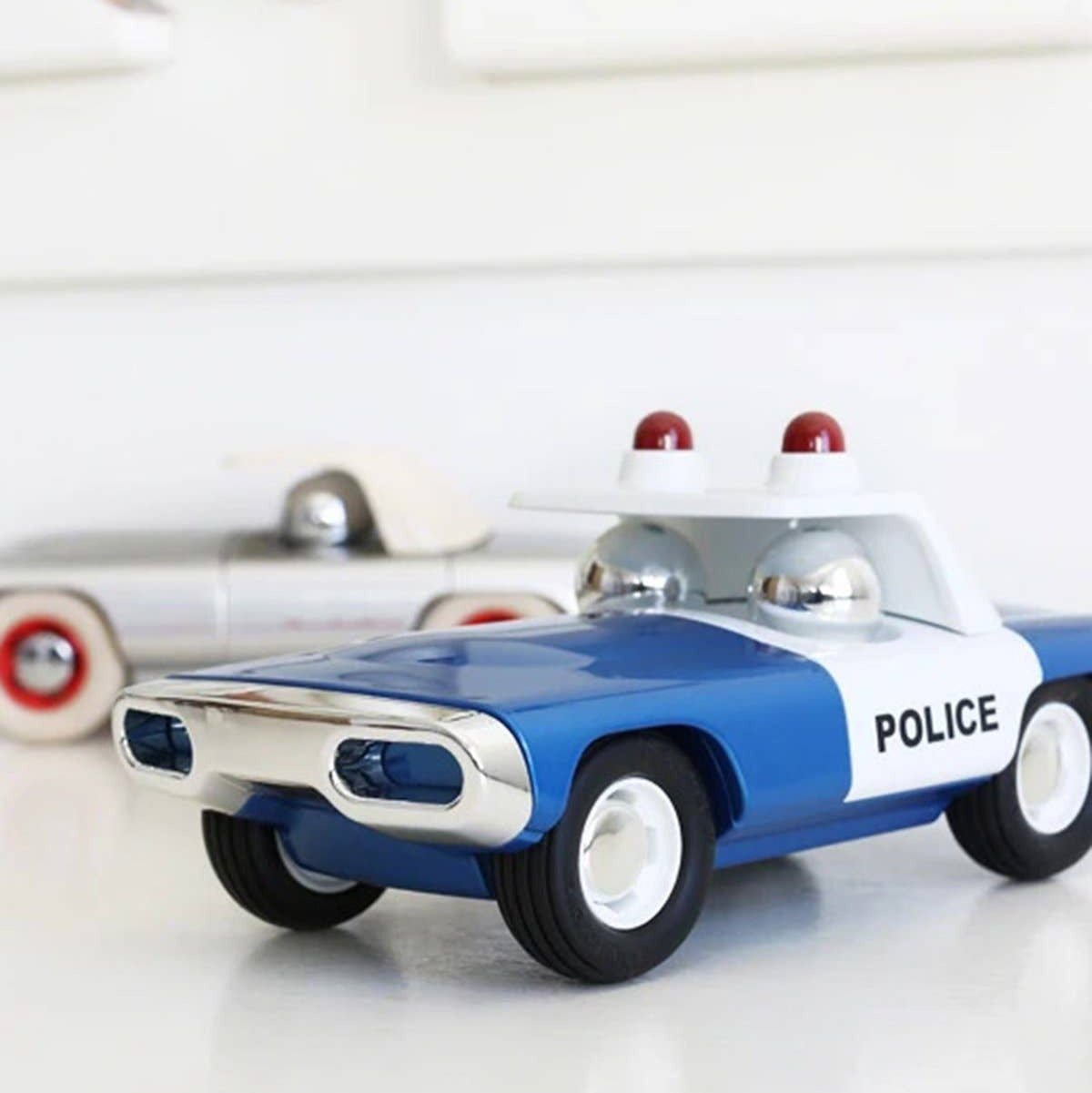 Toy police car on a white surface