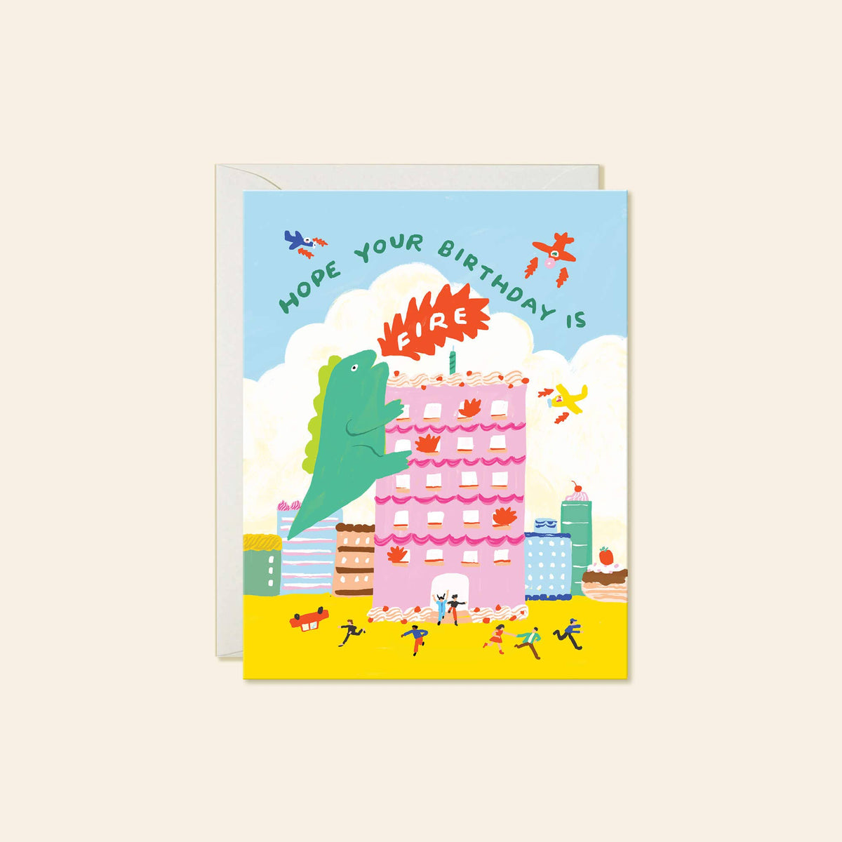 A birthday greeting card featuring a whimsical illustration of a green dinosaur climbing a pink birthday cake with flames, under a light blue sky and yellow ground, with the text 'MOPED YOUR BIRTHDAY IS' on the card.