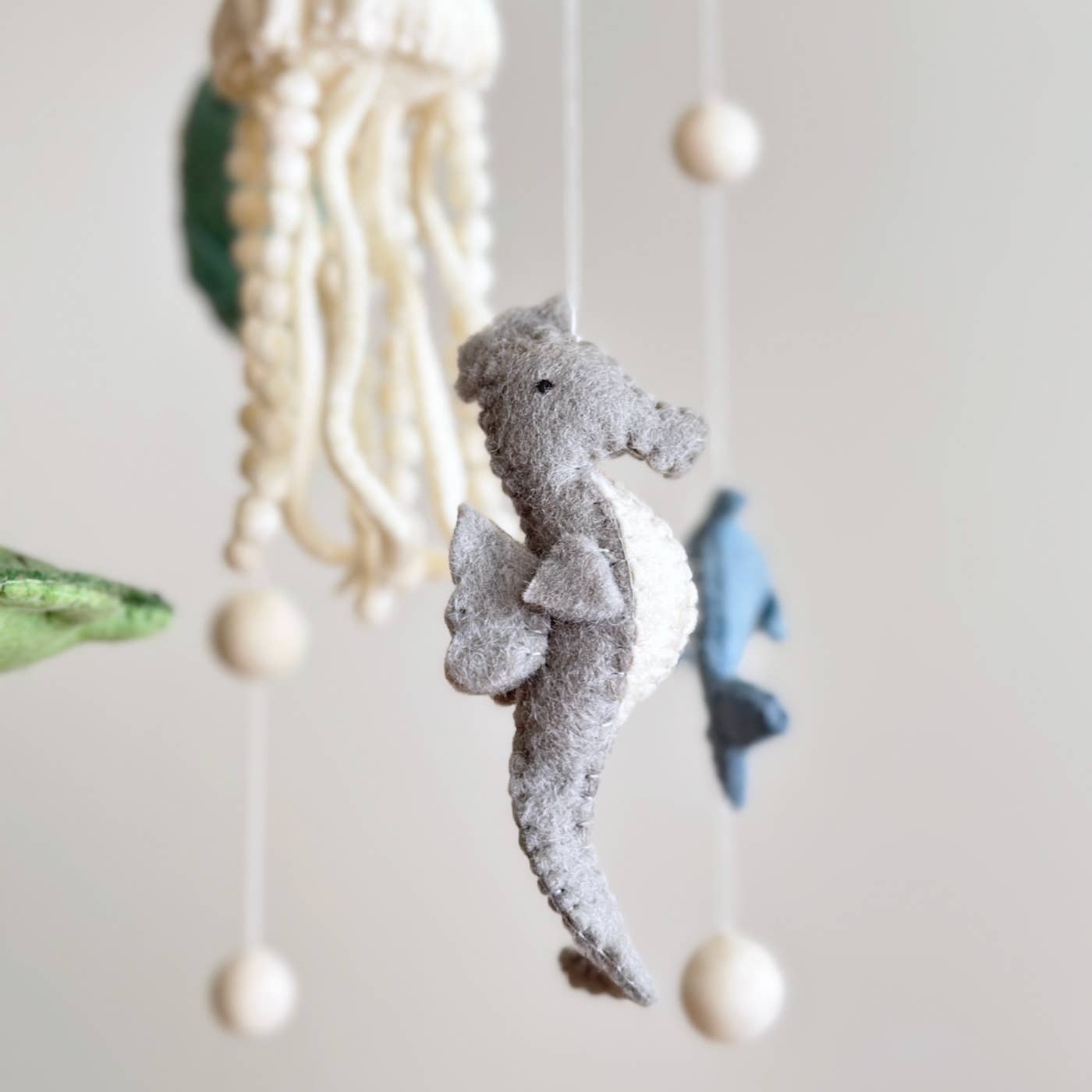 Decorative hanging mobile with sea-themed elements on a light background