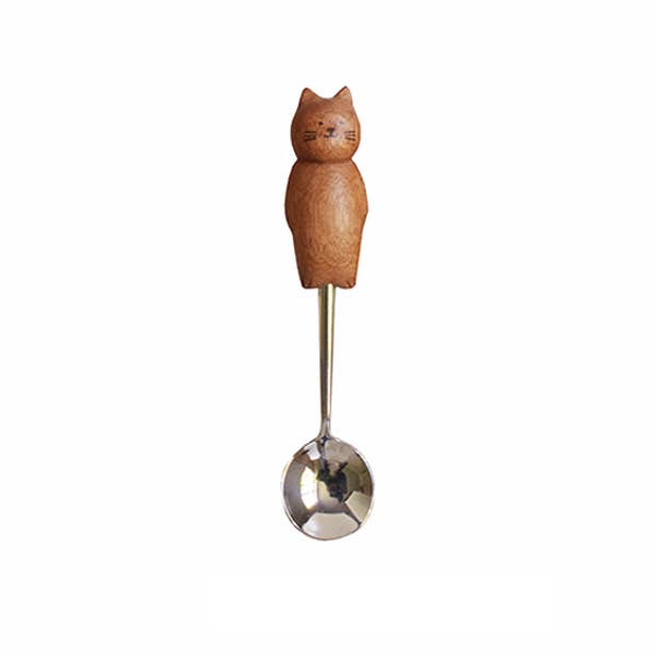 Wooden-handled spoon with cat design on a white background