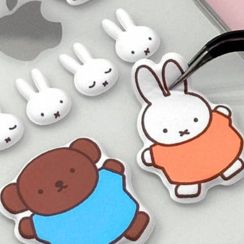 Cartoon bear and rabbit stickers on a pink background