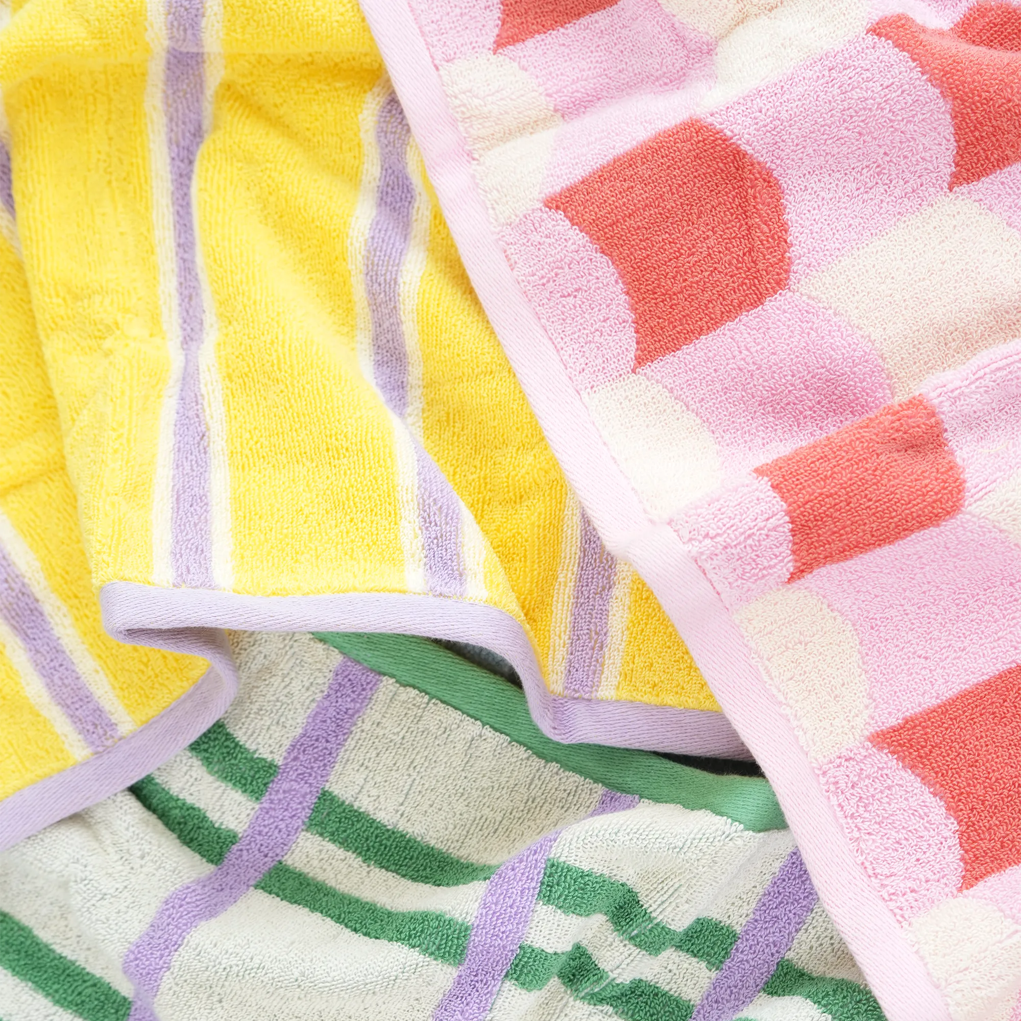 Colorful patterned towels on a white background