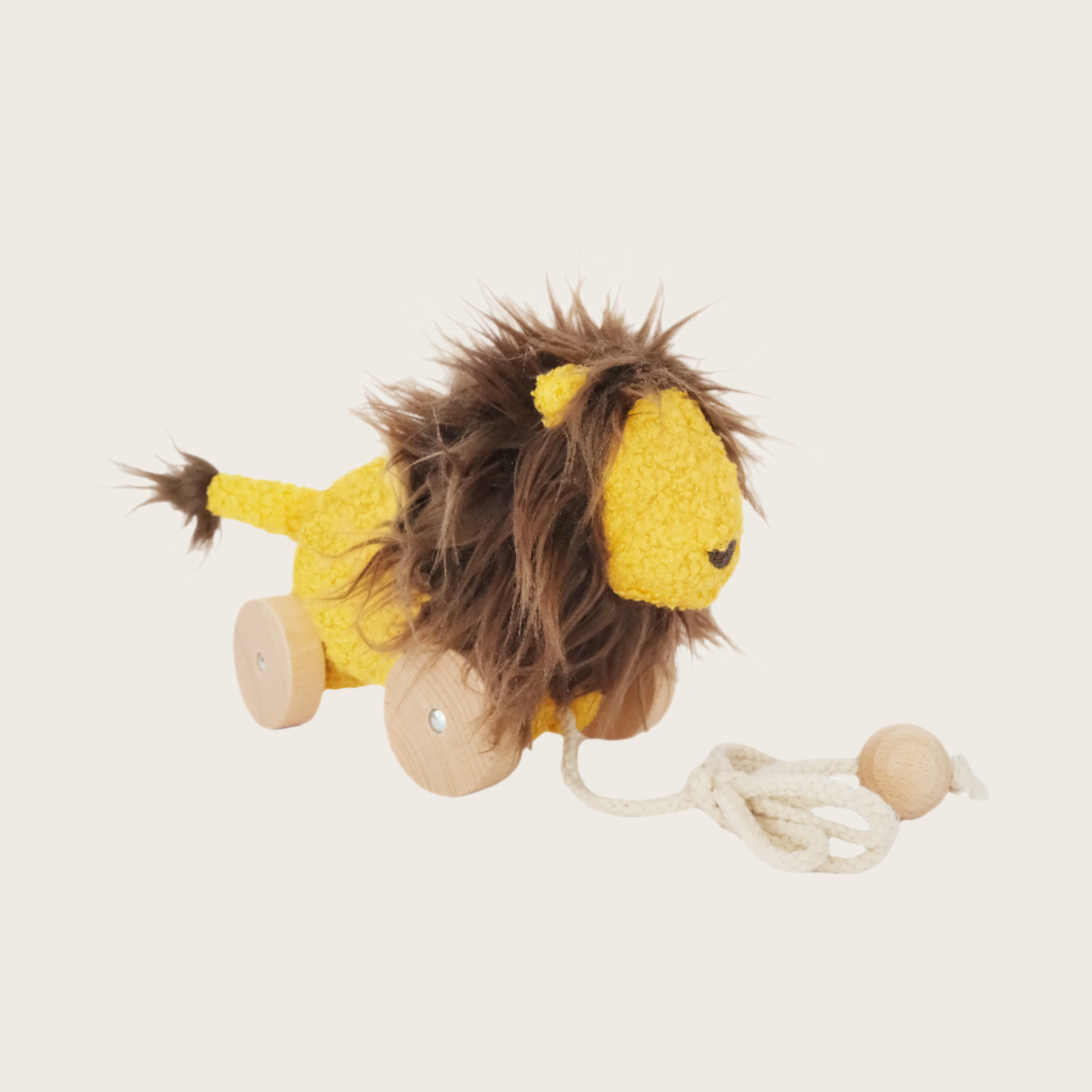 Yellow lion toy with string on white background