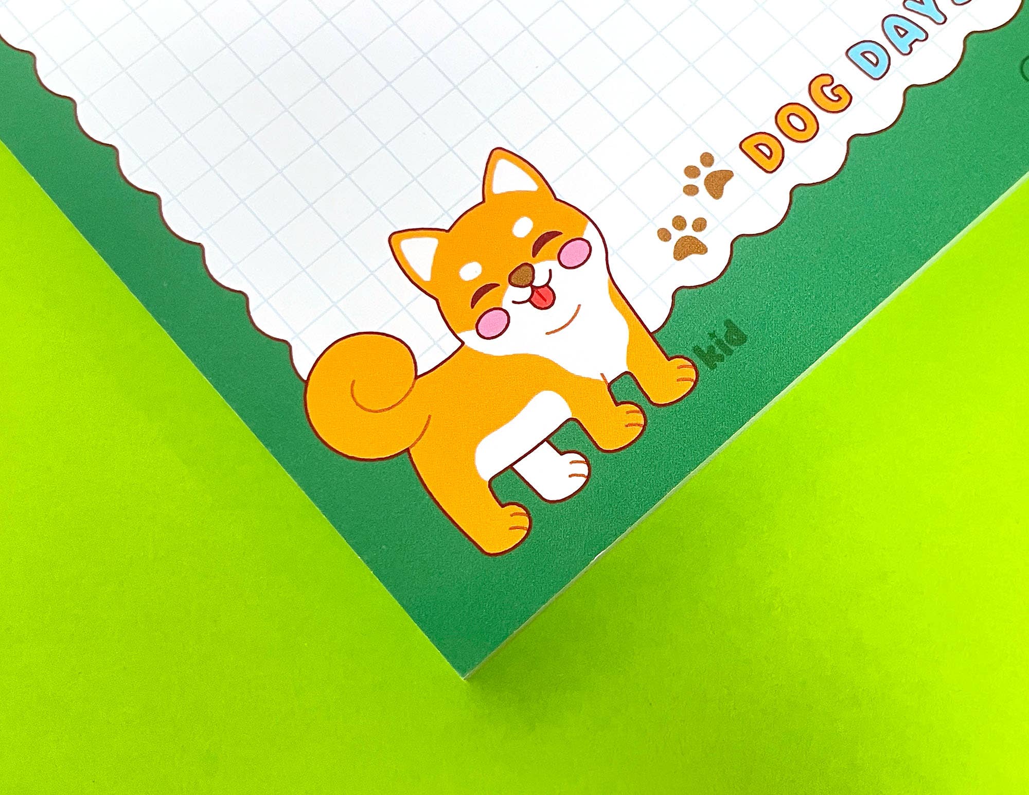 Notebook with a cartoon dog illustration on a green background