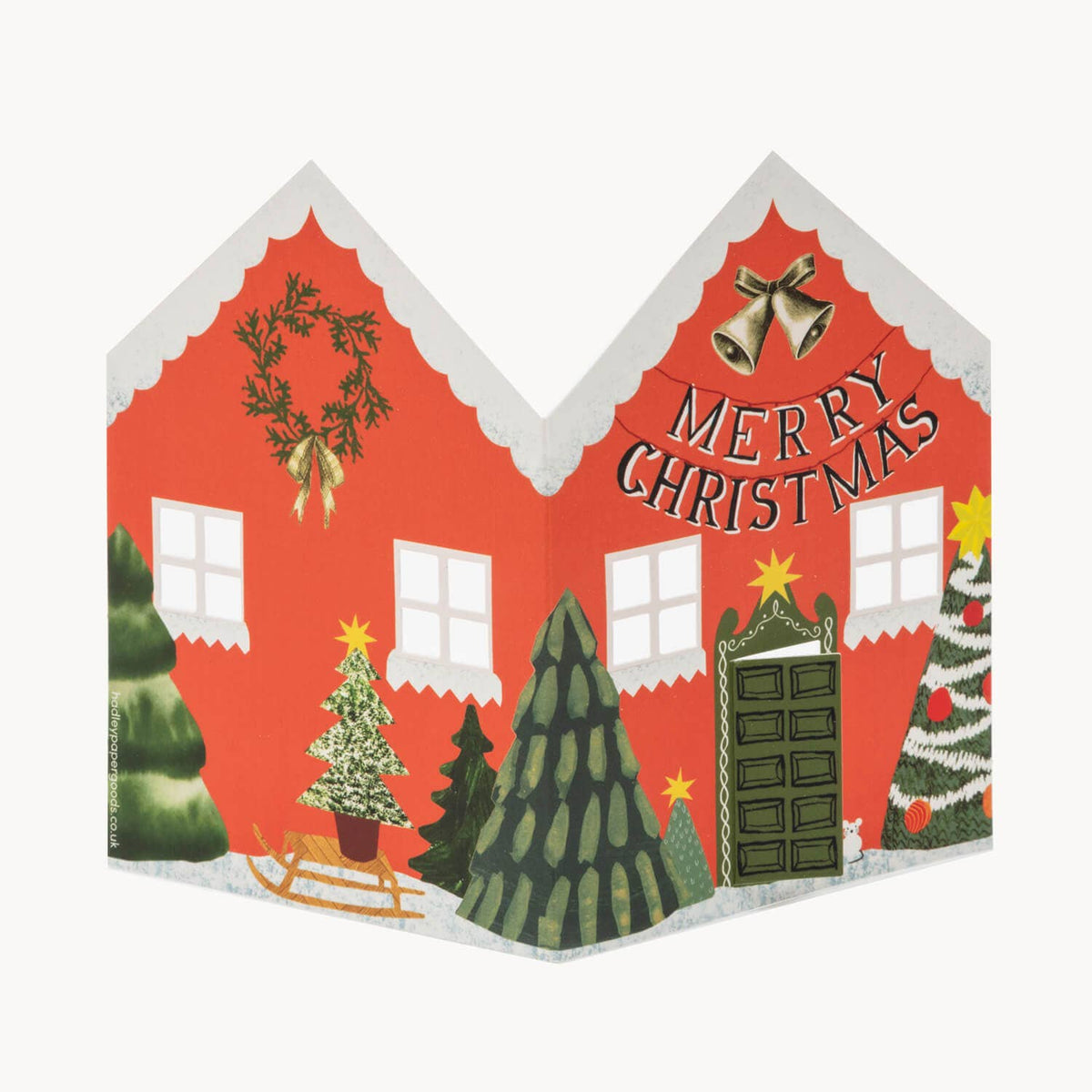 Christmas-themed house card with trees, sleigh, and 'Merry Christmas' text on a red background.