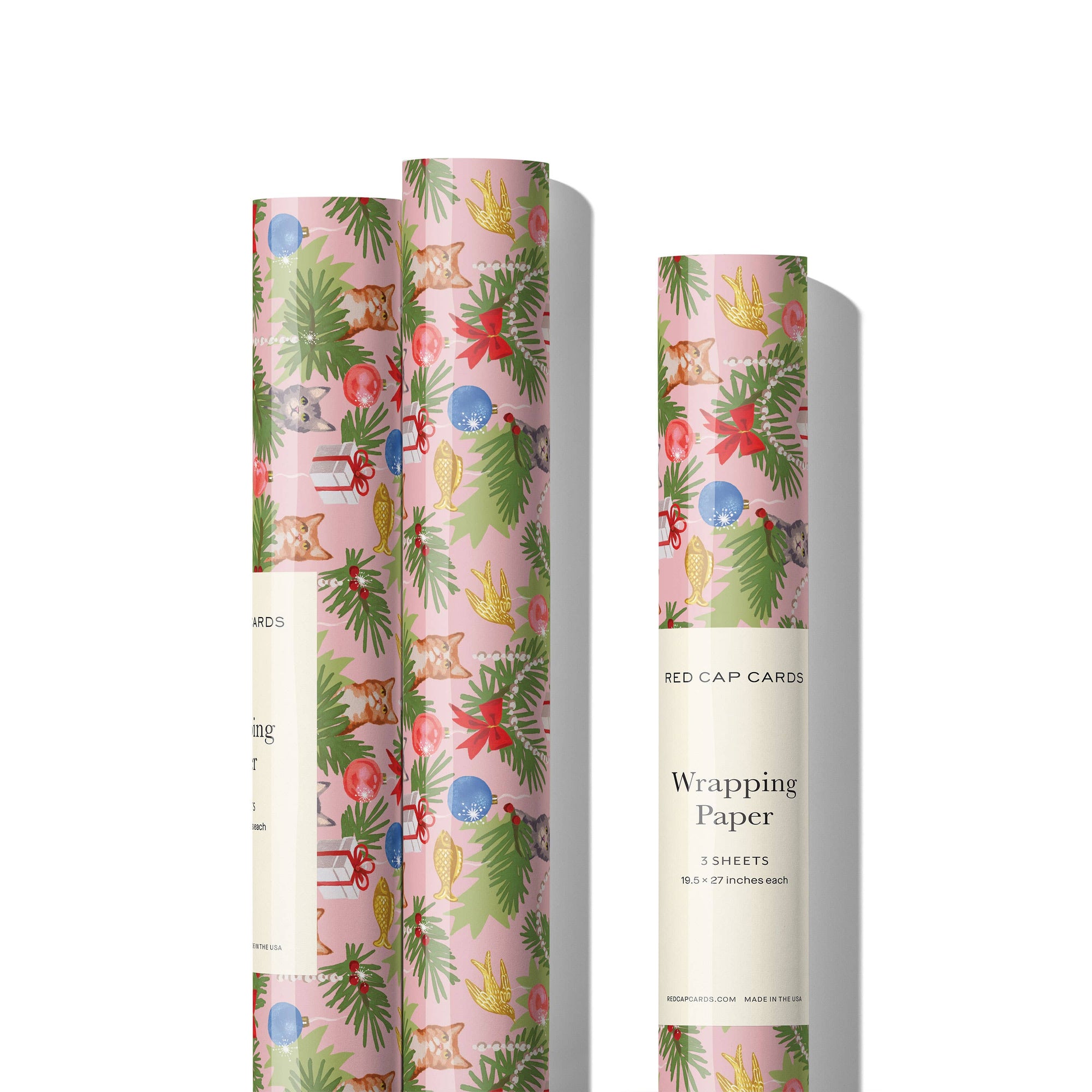 Rolls of festive wrapping paper with Christmas-themed designs on a white background.