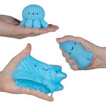 Blue octopus plush toy held between hands against a neutral background
