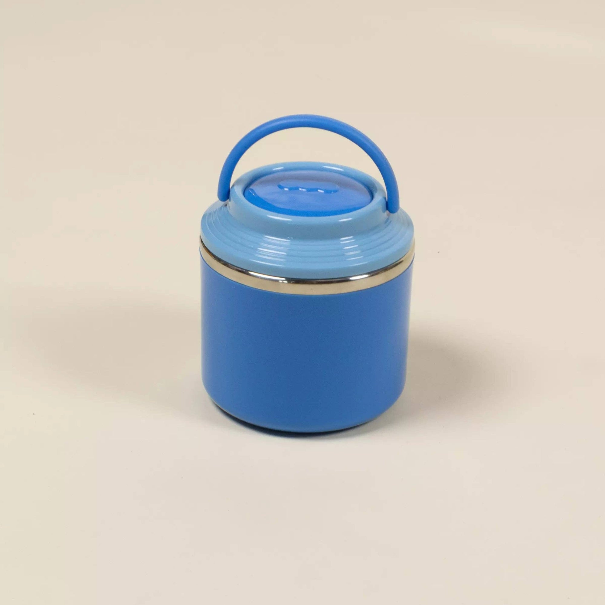 Blue container with a handle on a beige background