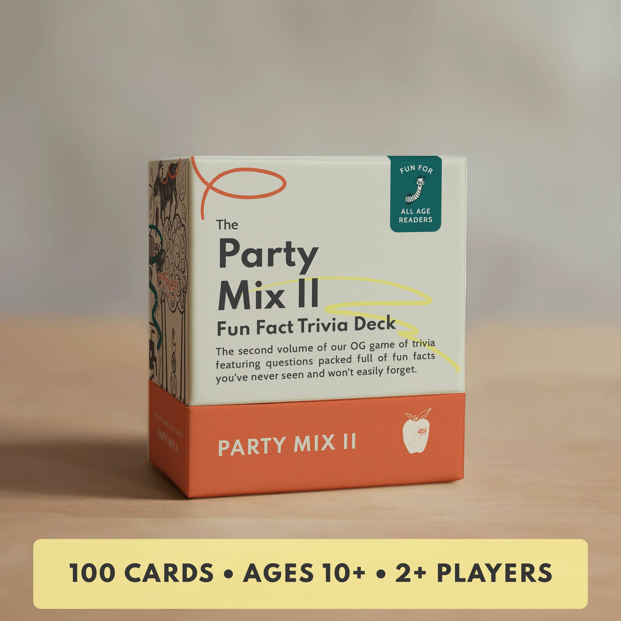 Party Mix II trivia deck packaging on a wooden surface with a neutral background