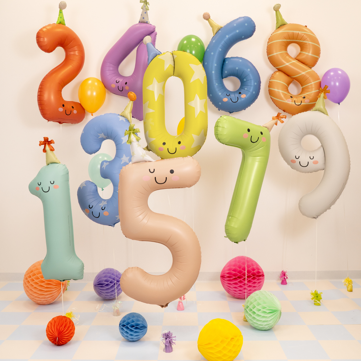 Colorful number balloons with faces on a checkered floor.
