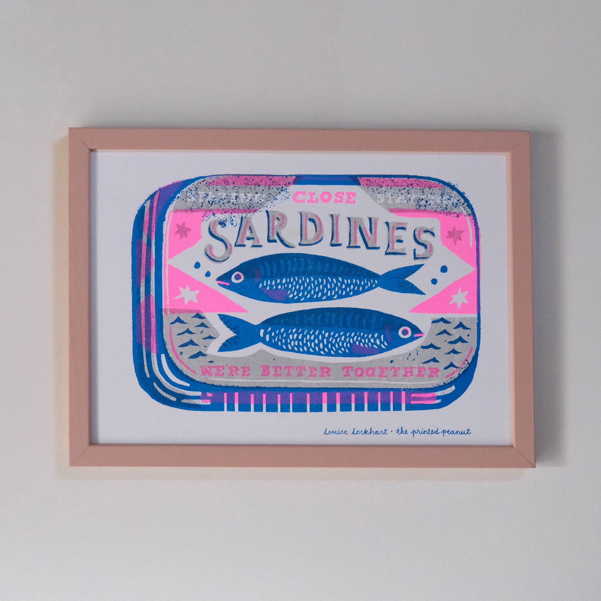 Framed artwork of a sardine can design with blue fish on a white background