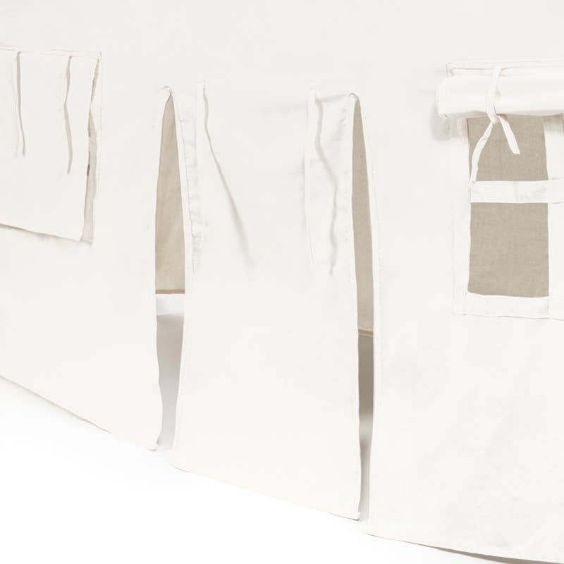 White aprons with pockets hanging on a line against a white background
