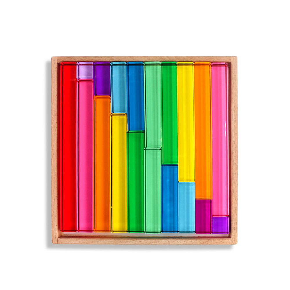 Colorful wooden blocks in a wooden box on a white background