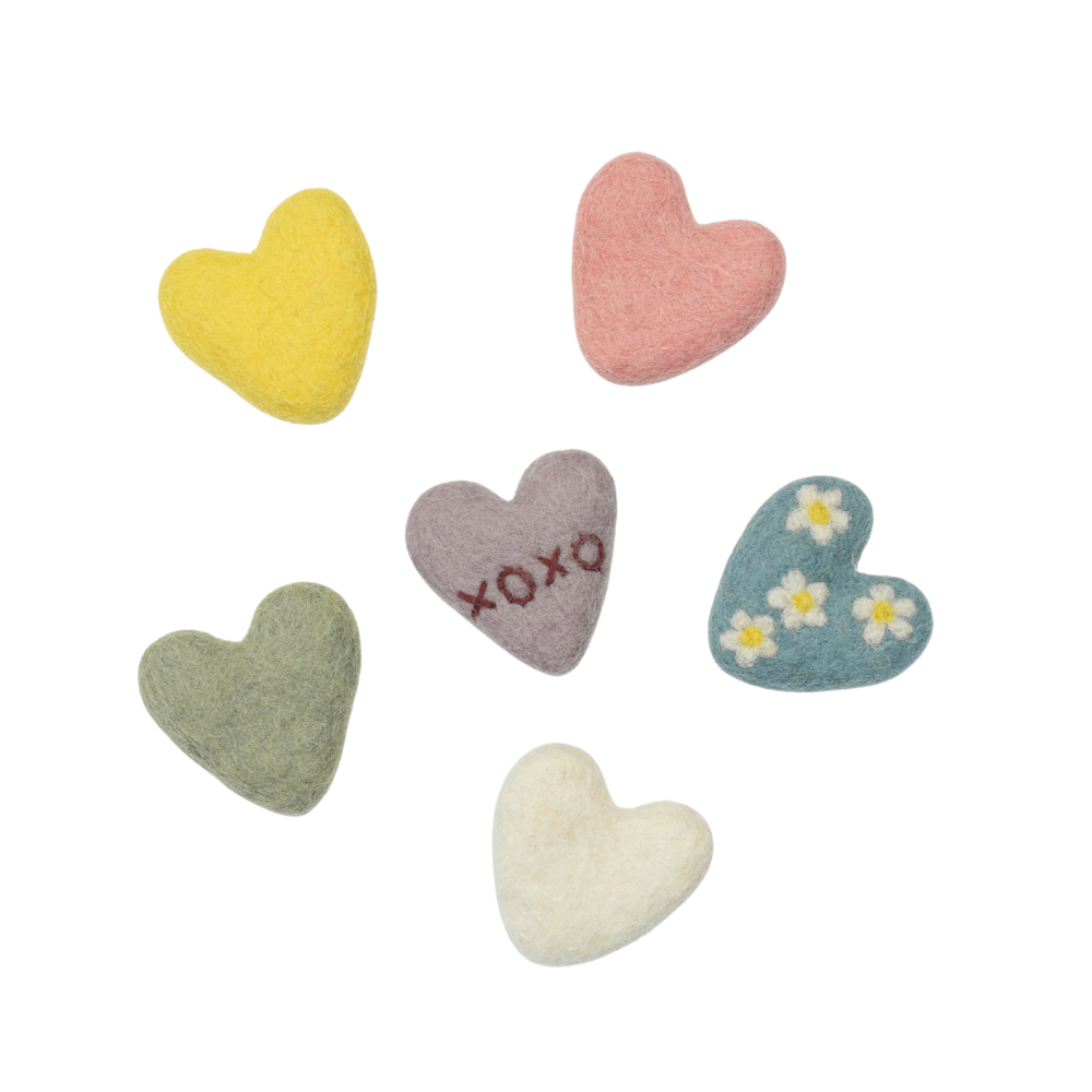 Set of colorful heart-shaped plush toys on a white background