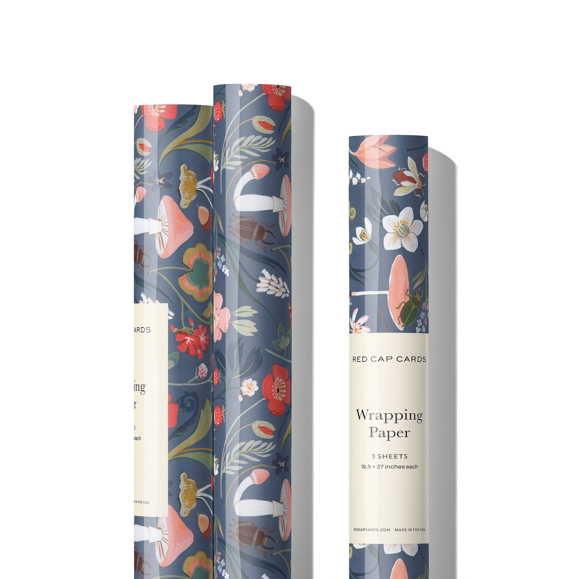 Three rolls of floral wrapping paper with 'Red Cap Cards' branding on a white background.