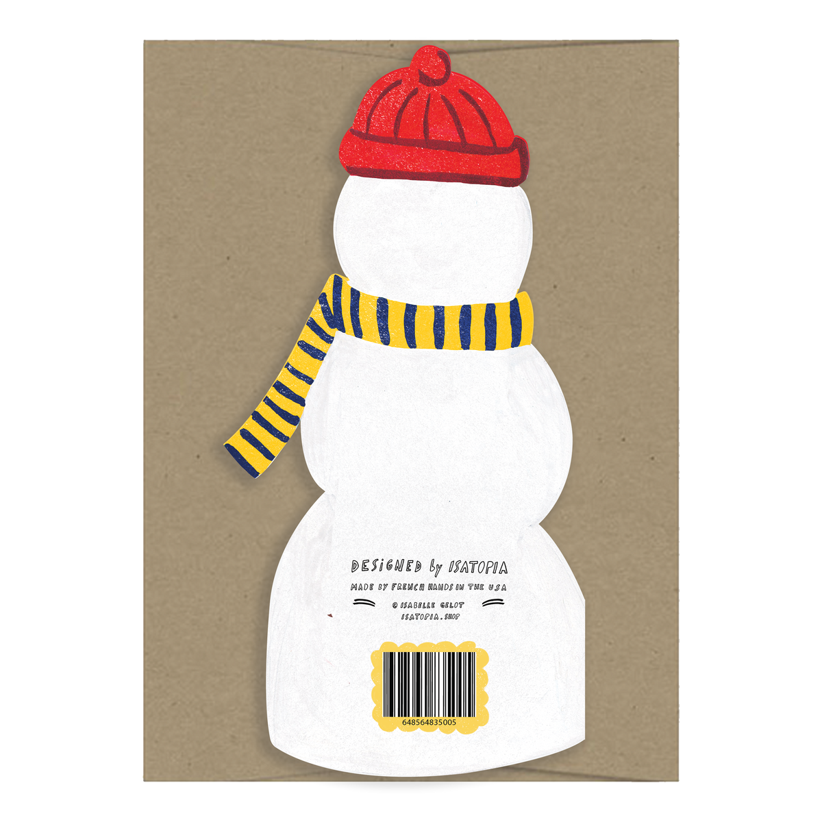 A white paper snowman cutout with a red knit hat, yellow and navy striped scarf, and printed text near the bottom, displayed on a brown kraft paper background.