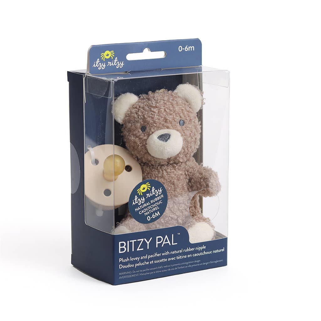 Plush toy bear in packaging with 'itzy ritzy' branding on a white background