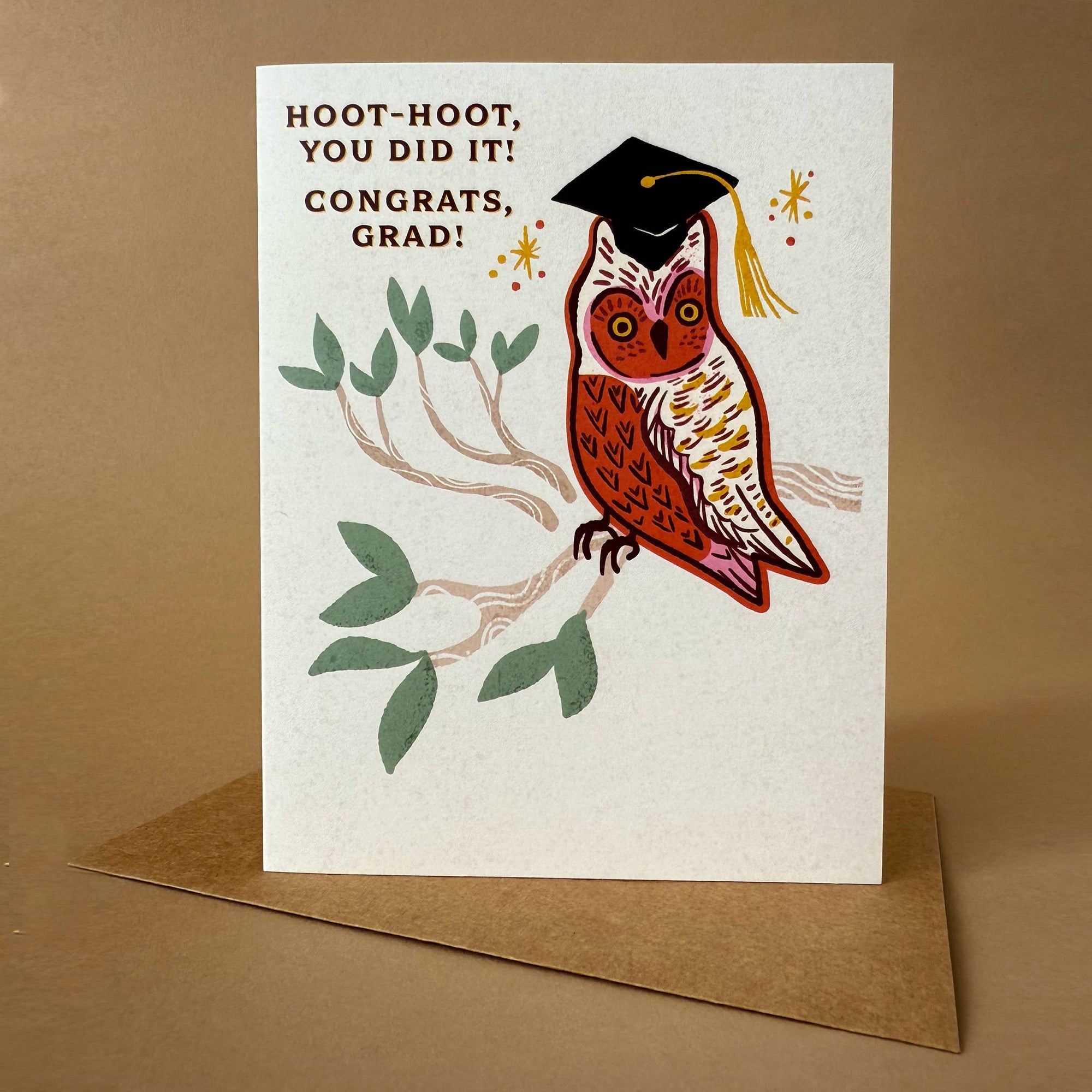Graduation card with an owl wearing a cap and tassel on a beige background
