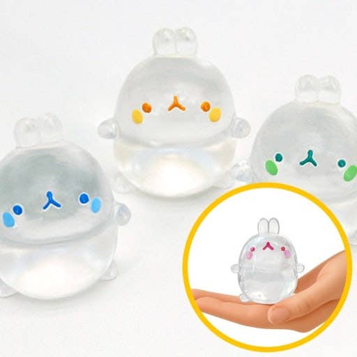 Clear silicone animal-shaped containers with colorful faces on a white background