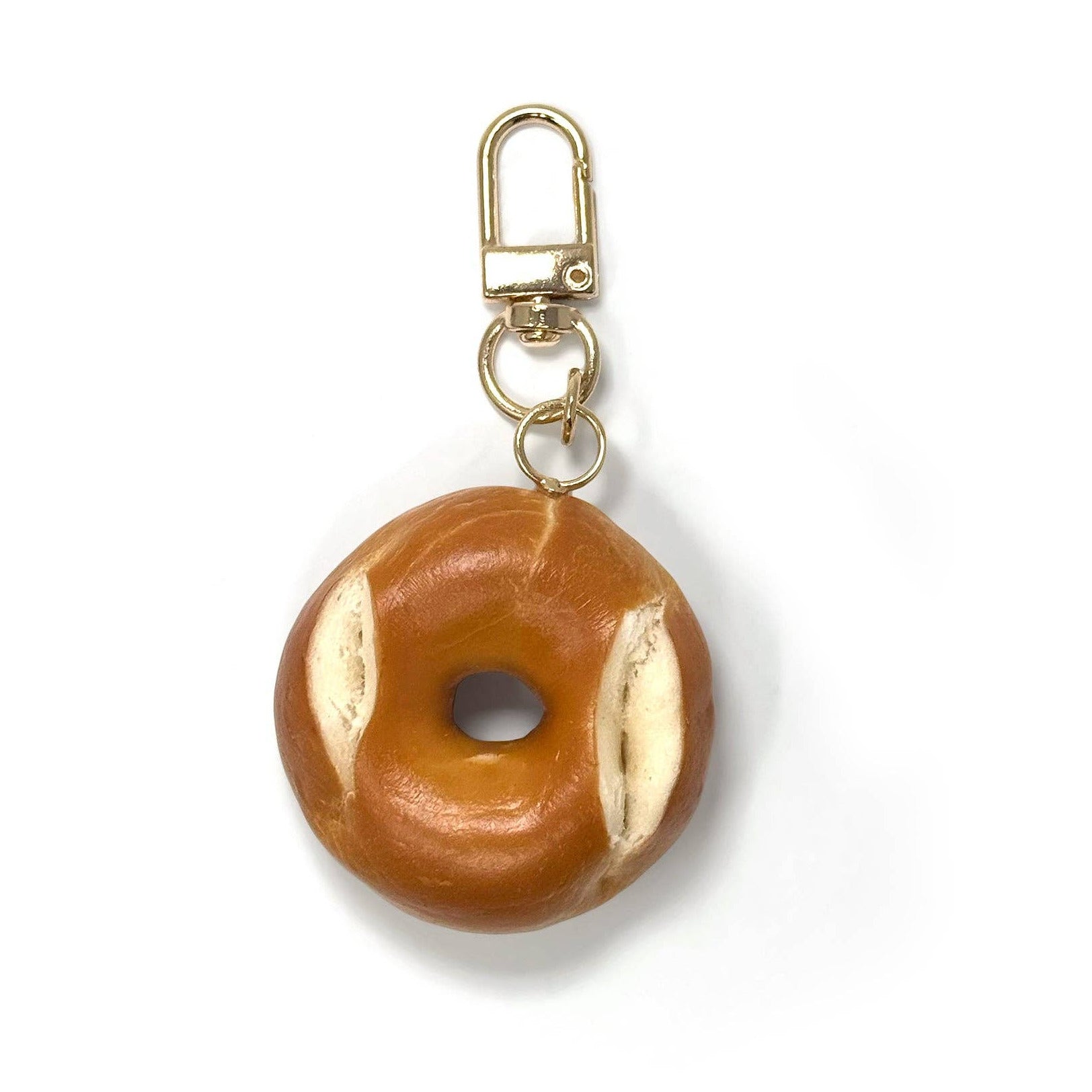 bagel-shaped  keychain with gold accents on a white background