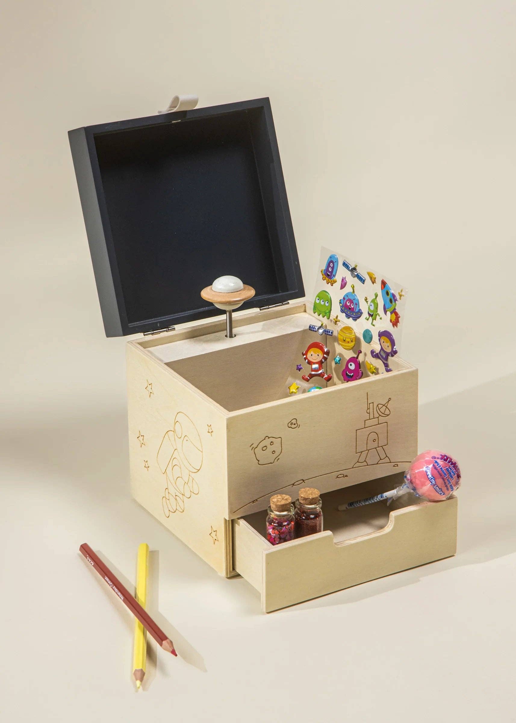 Wooden toy with animated figures and a screen on a beige background