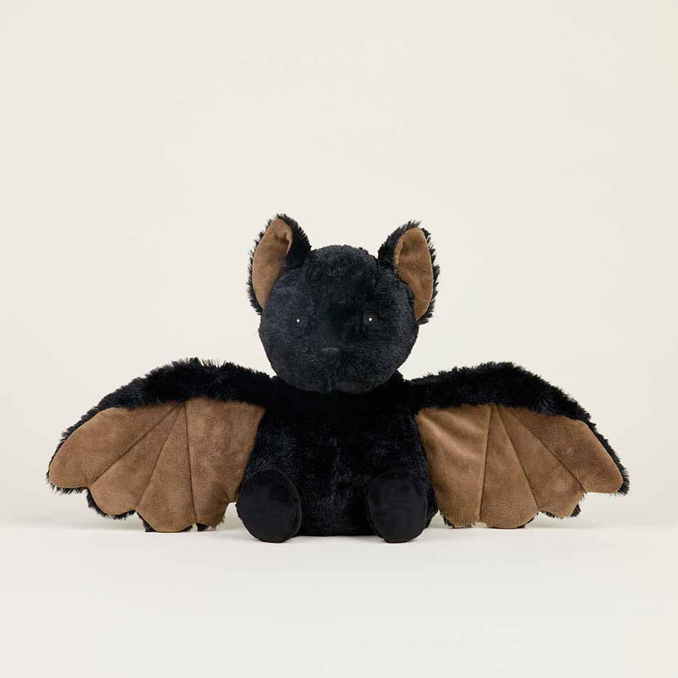 A black plush toy bat with brown wings, sitting against a plain off-white background.