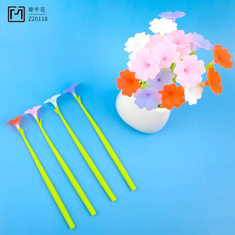Colorful flower-shaped straws on a blue background with a vase of flowers.