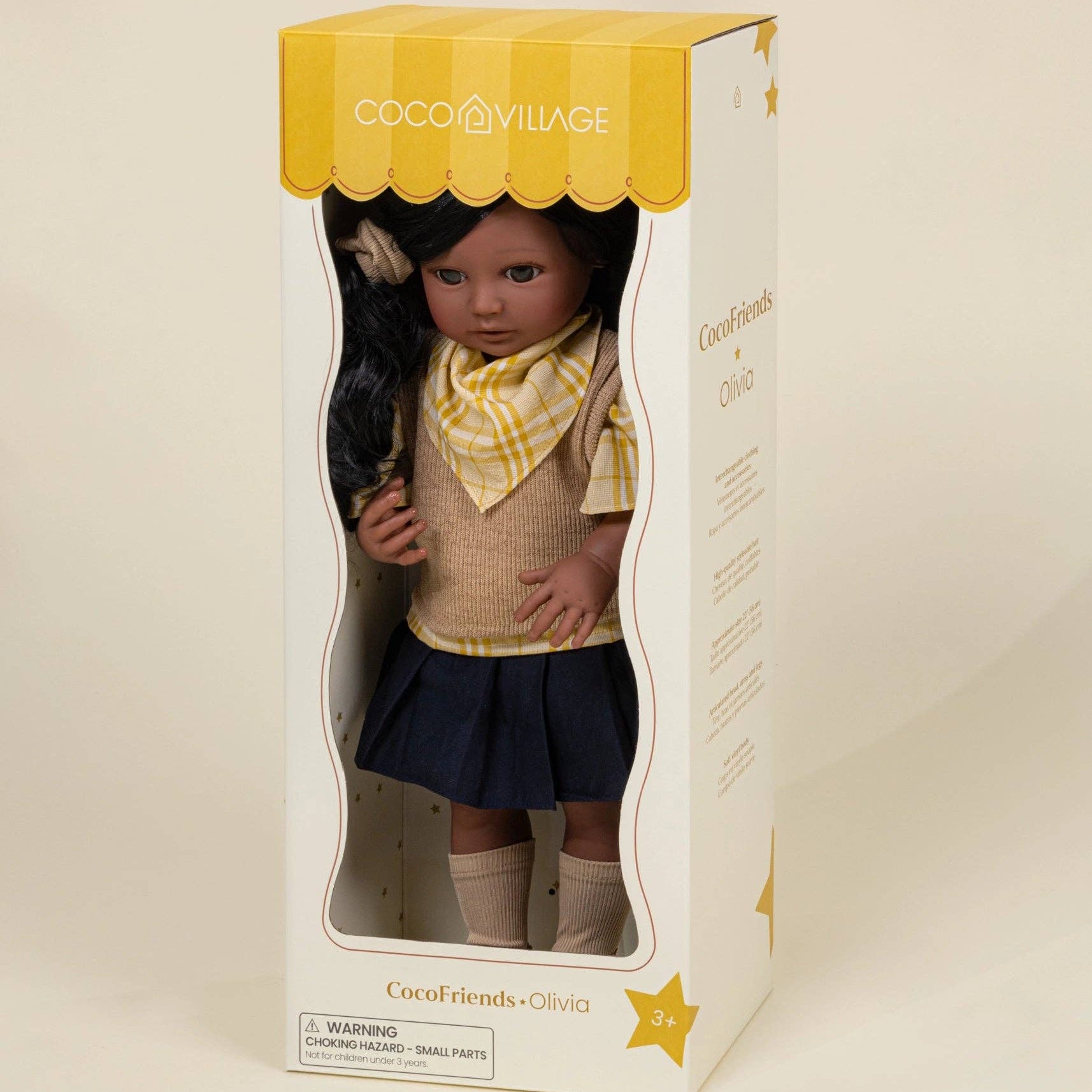 Doll in a box with yellow and white packaging, featuring the brand 'Cocco Village'.