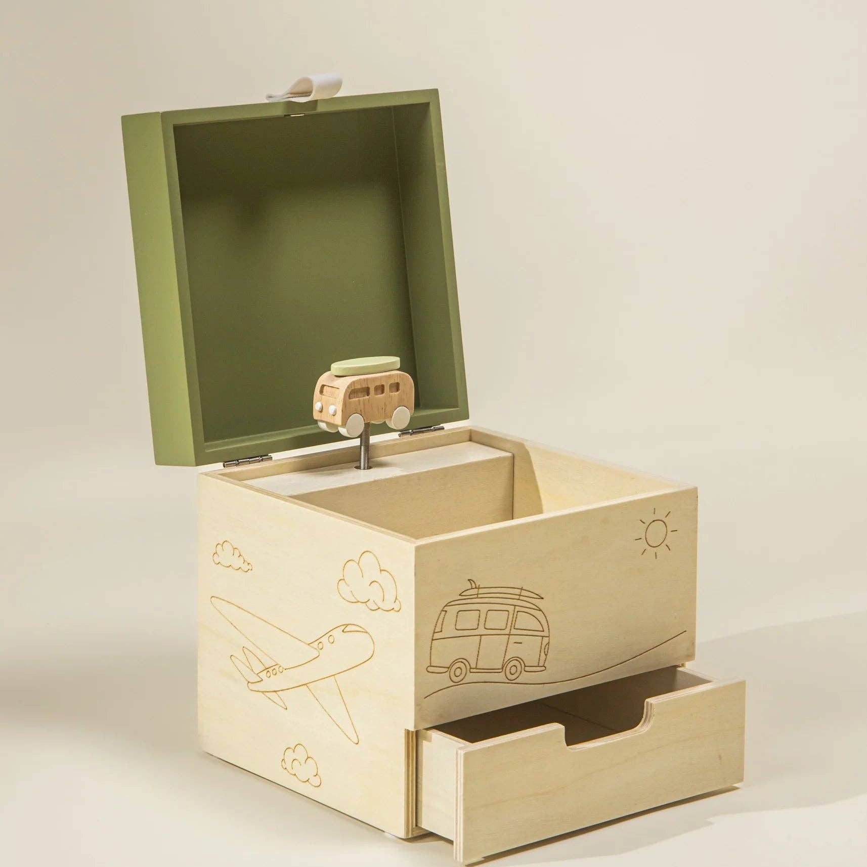 Wooden music box with open lid and drawer on a beige background