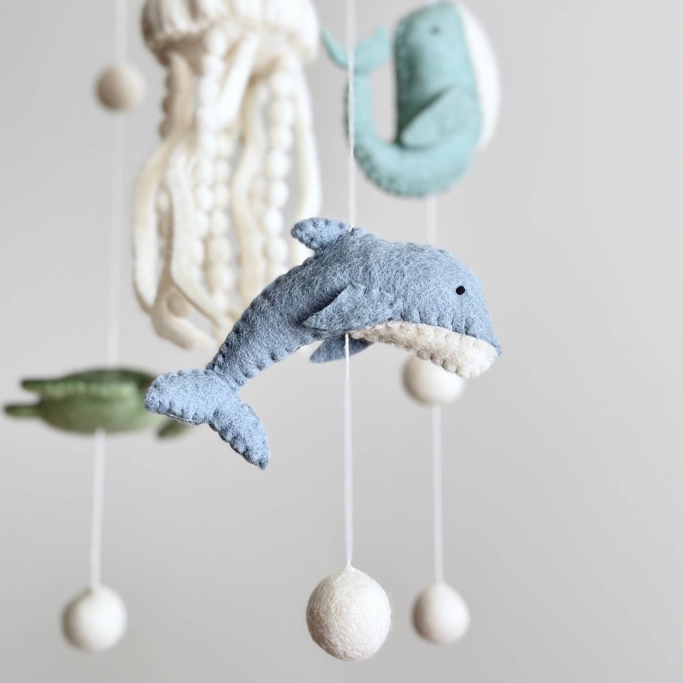 Decorative mobile with whale and sea-themed elements on a plain background