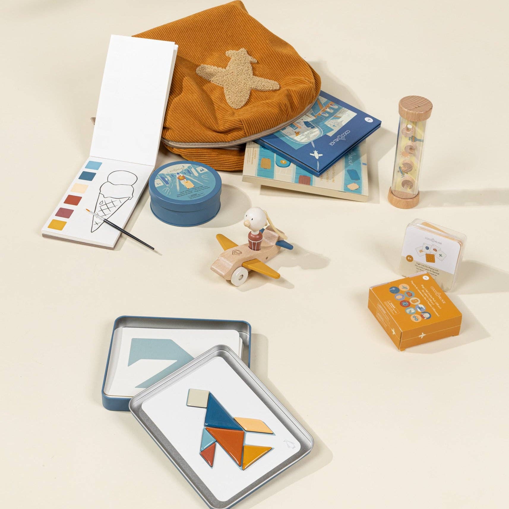 Collection of children's toys and educational items on a beige surface