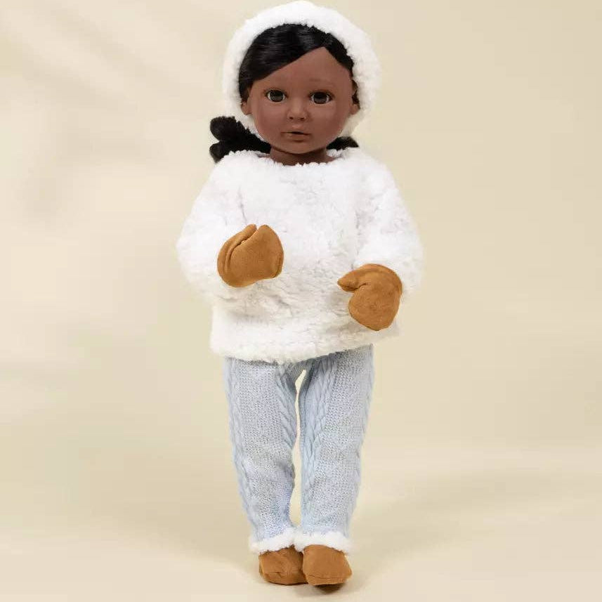 Doll wearing a white outfit with a hood on a beige background