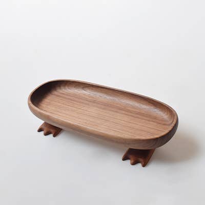 Wooden tray with animal-like feet on a white background