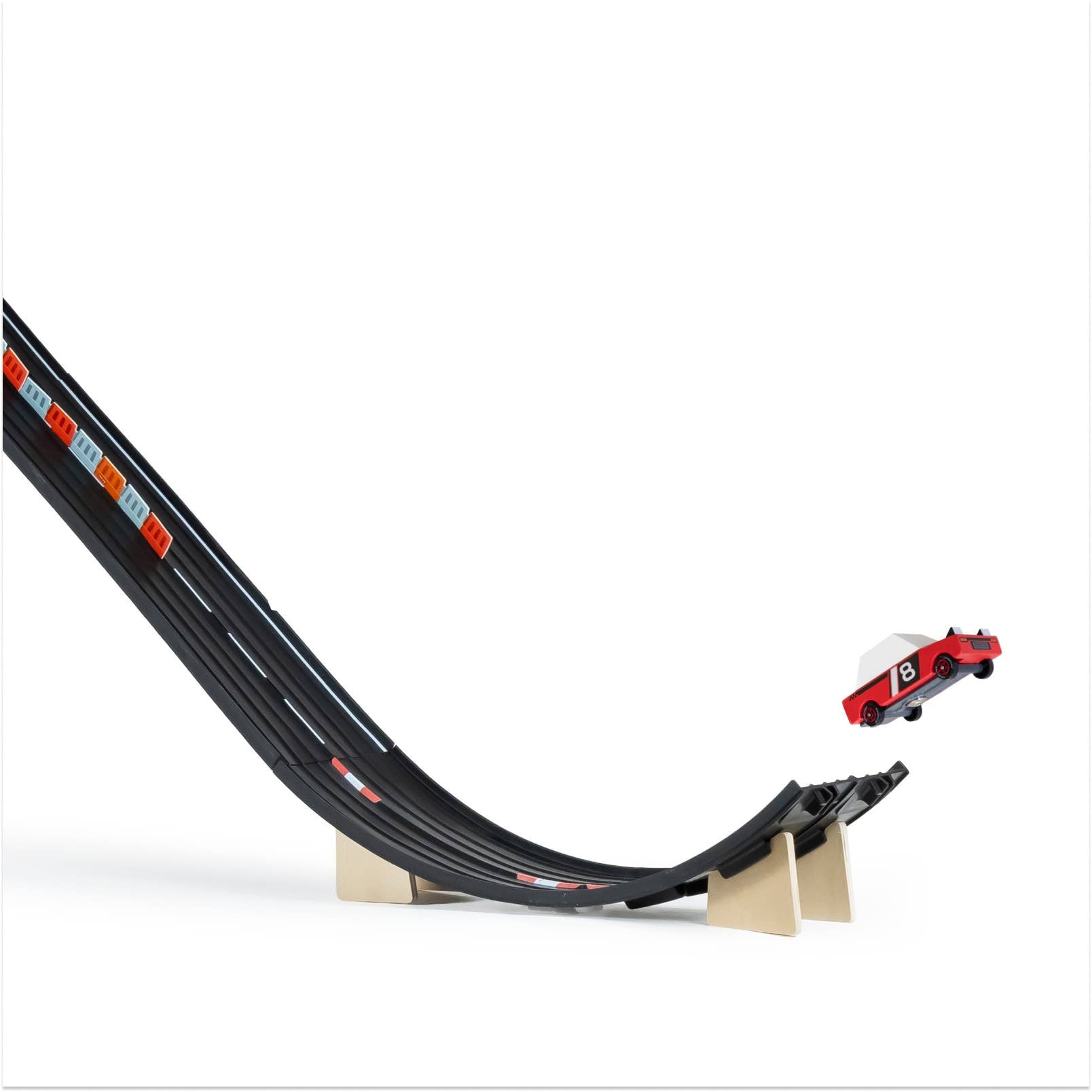 Toy car on a black track with red and blue accents on a white background