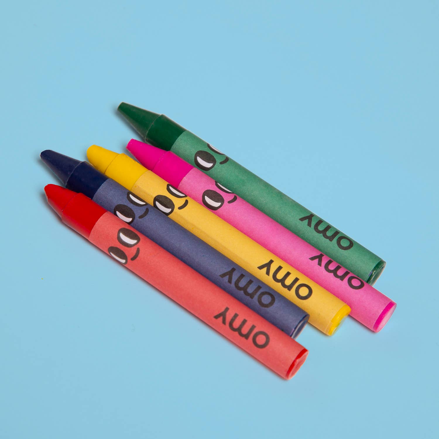 Colorful crayons with faces on a blue background