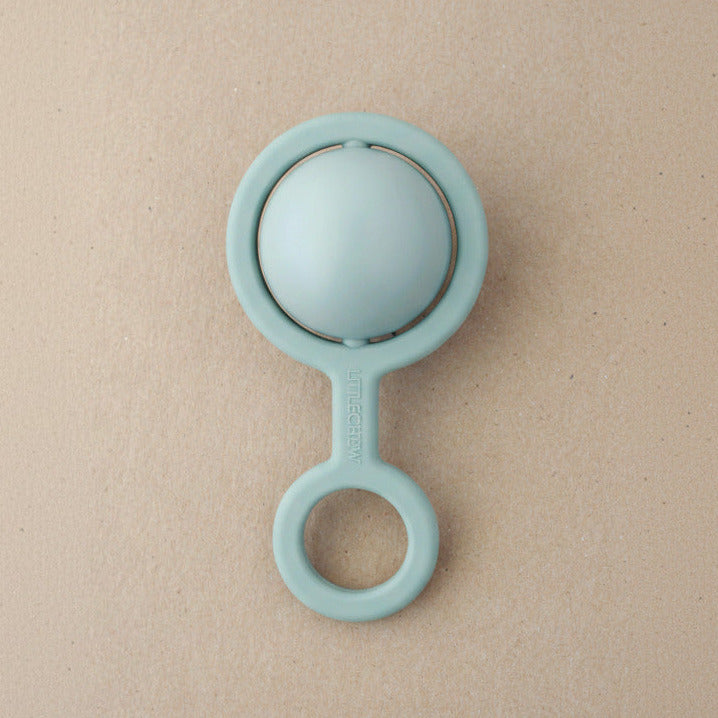 Light blue teething ring on a beige background
