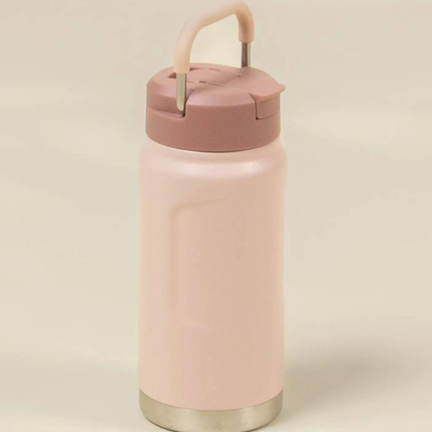Pink insulated bottle with a handle on a beige background