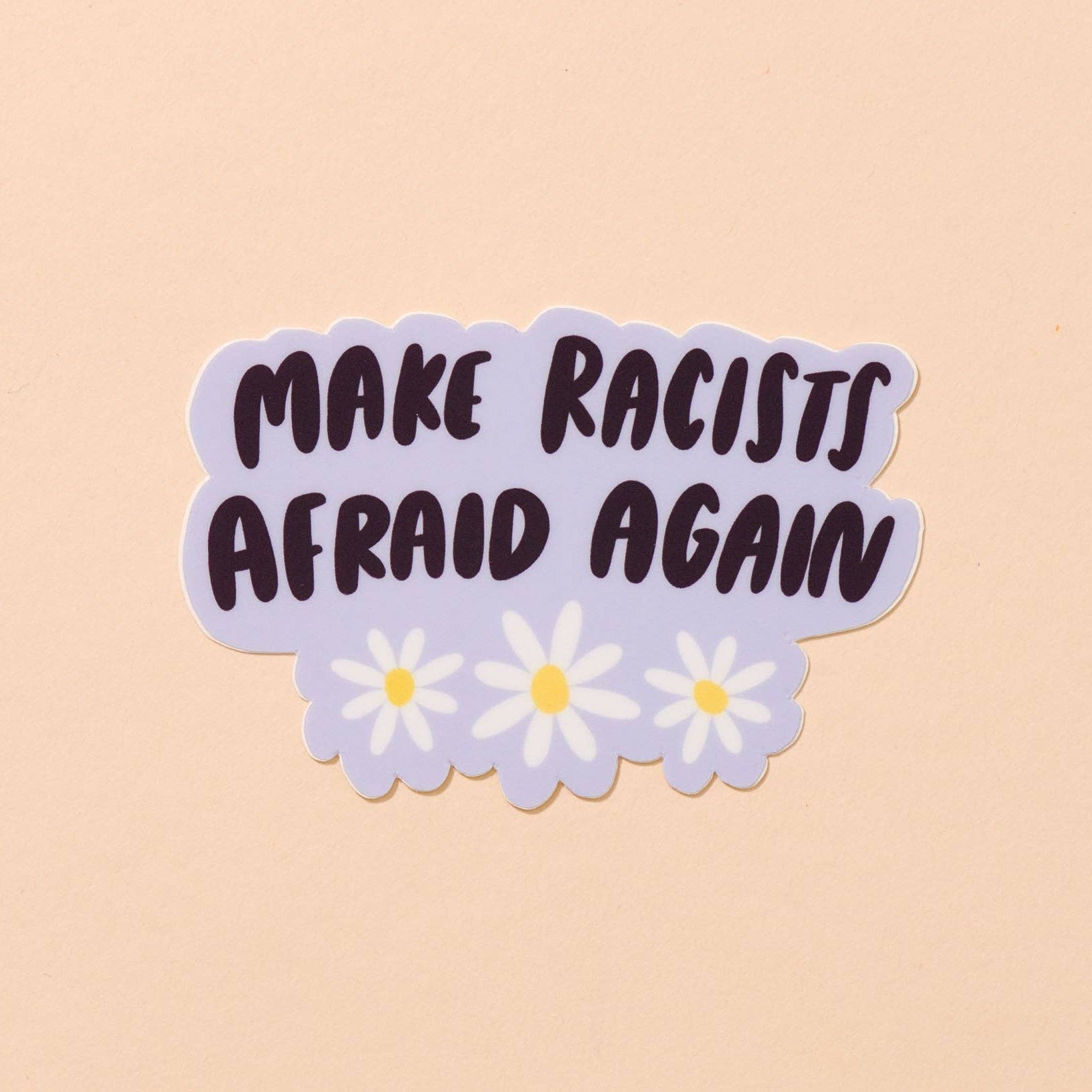 Sticker with 'MAKE RACISTS AFRAID AGAIN' text on a beige background