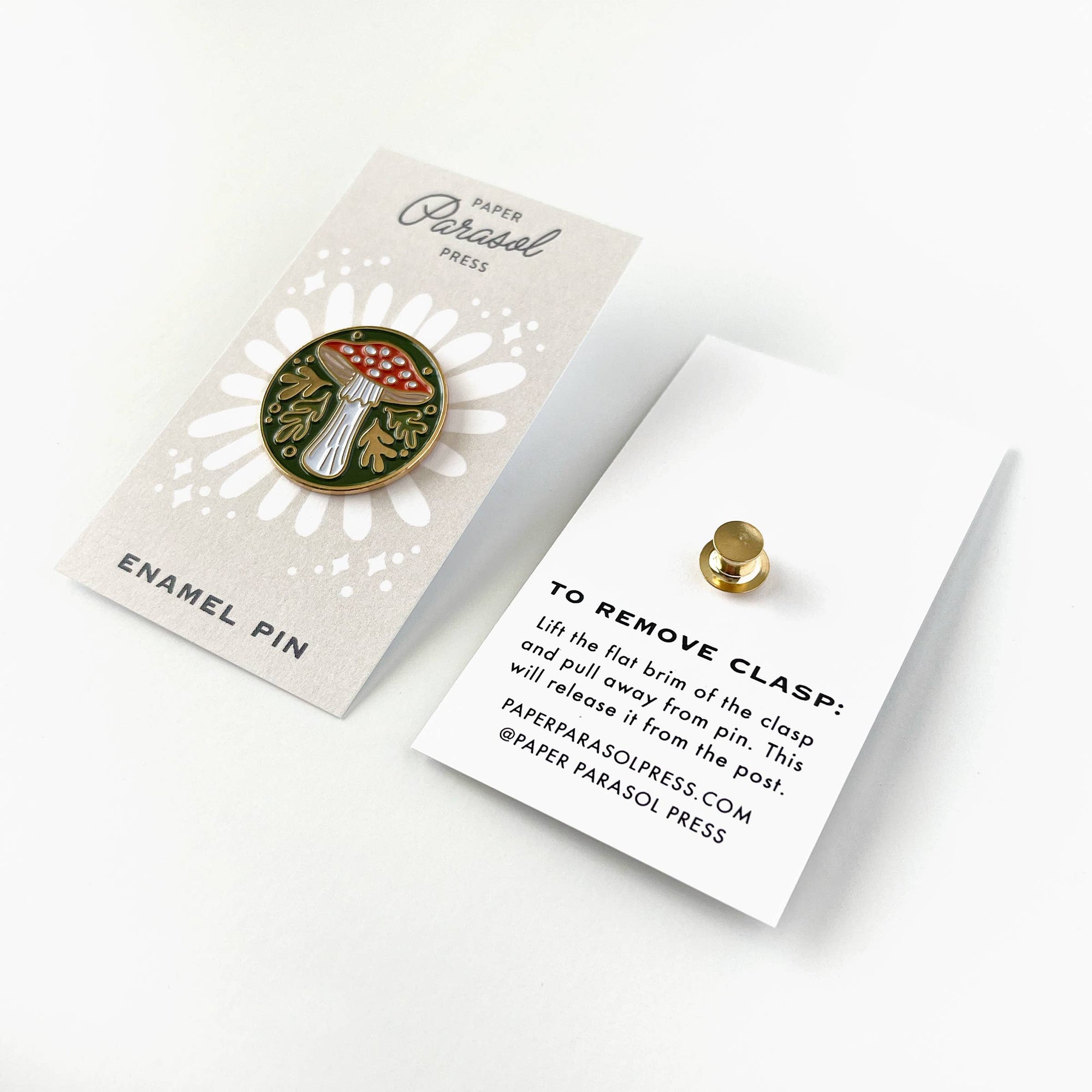 Enamel pin with mushroom design on a branded card