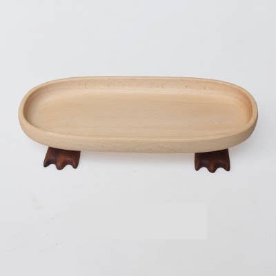 Beige wooden tray with wooden feet on a white background