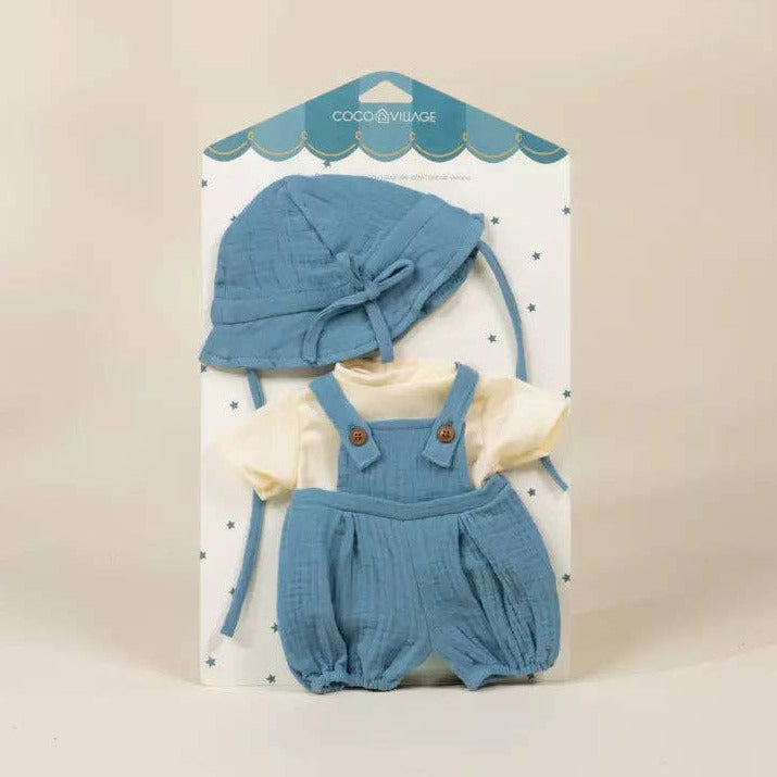 Baby outfit set with blue romper and hat on a beige background