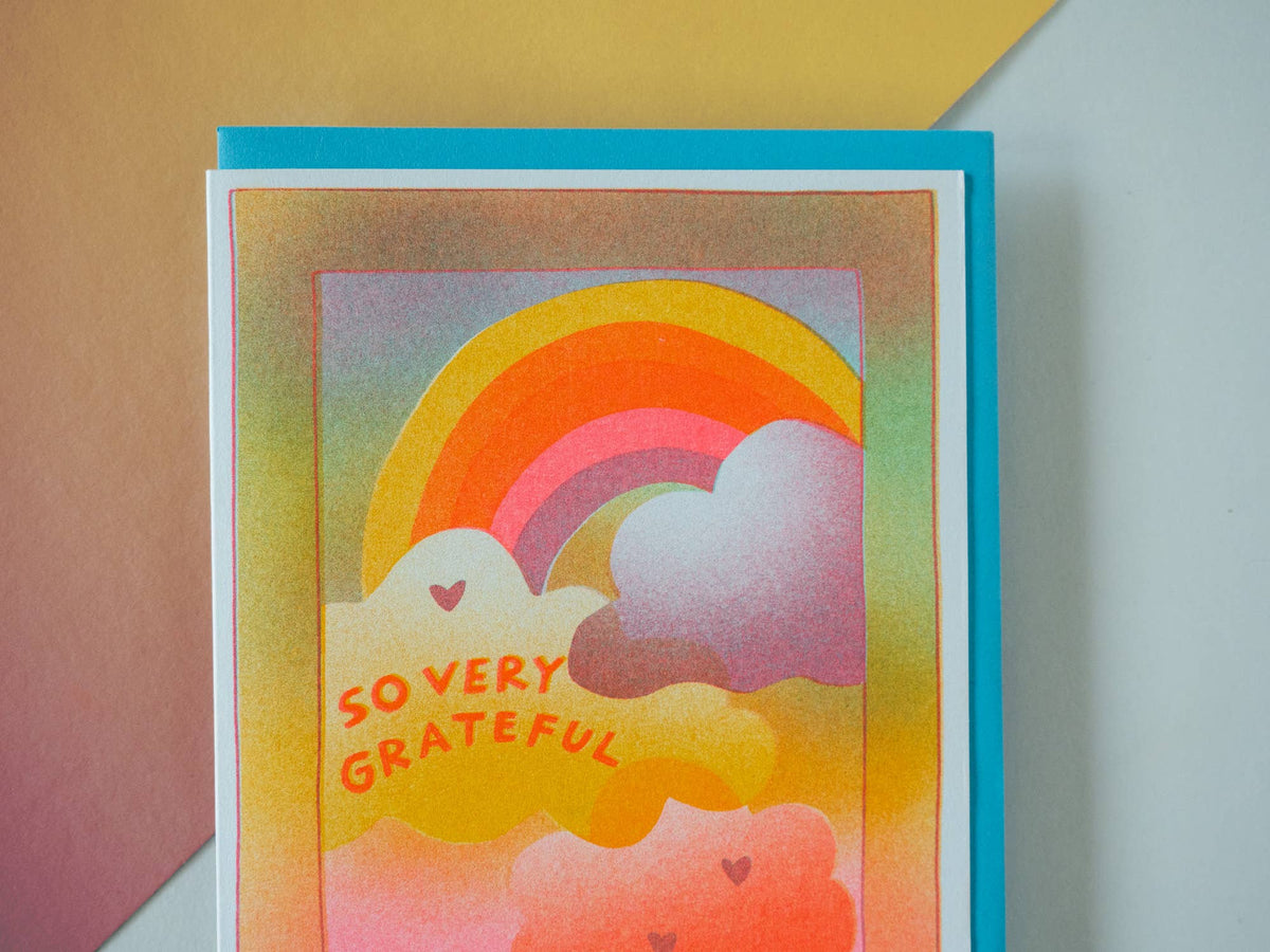 Card with rainbow and clouds design and 'So Very Grateful' text on a colorful background