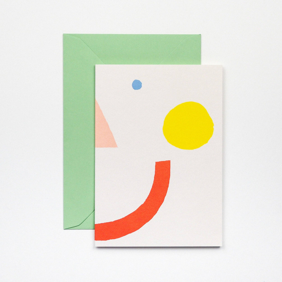 Greeting card with geometric shapes and a green envelope on a white background
