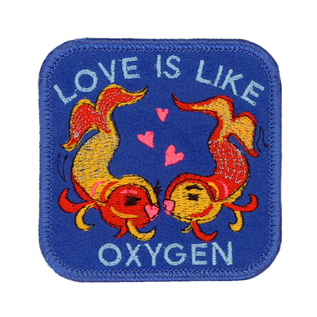Embroidered patch with two fish and text 'Love is Like Oxygen' on a blue background