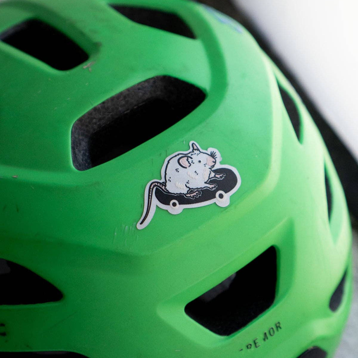 Green helmet with a sticker on a white background