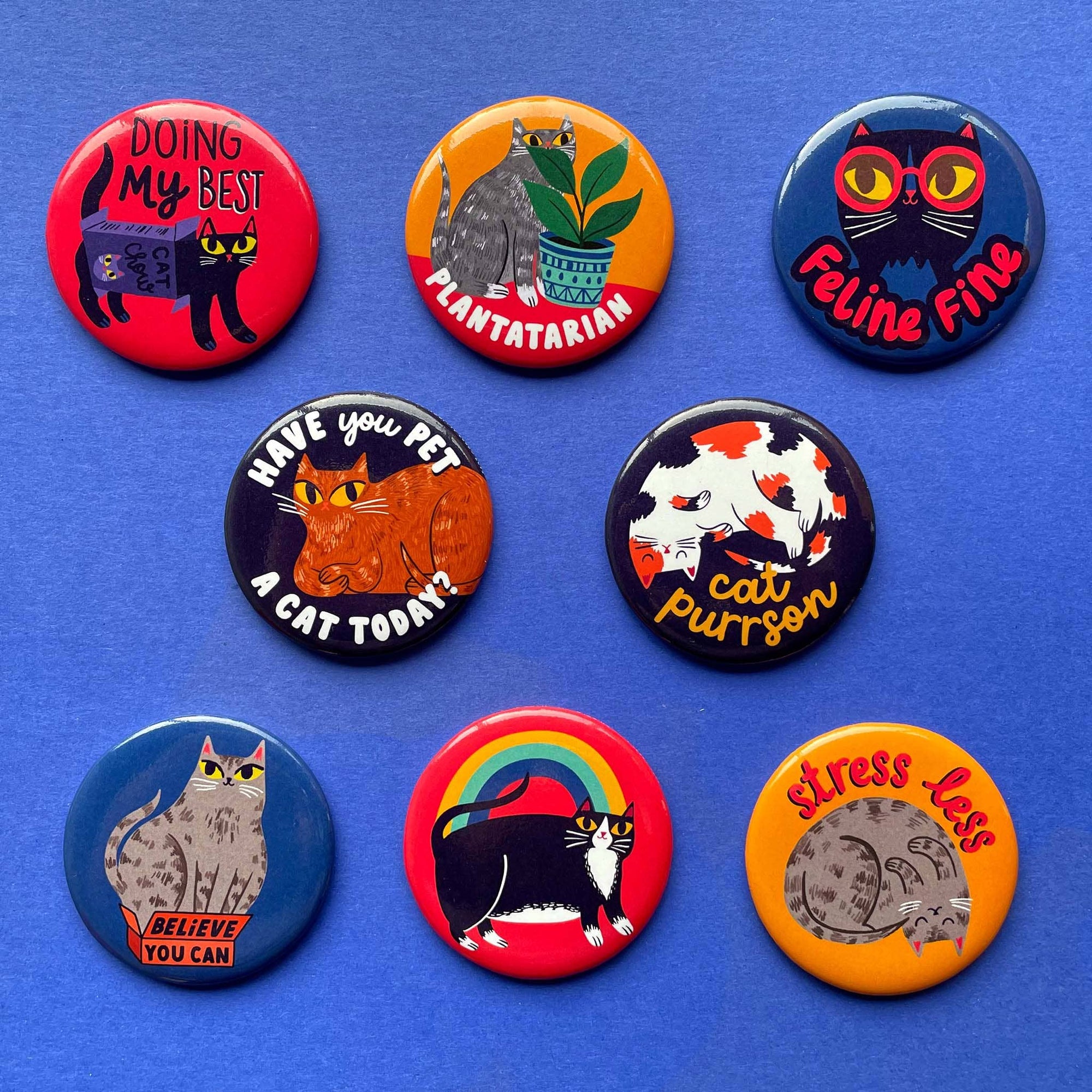 Set of cat-themed buttons on a blue background
