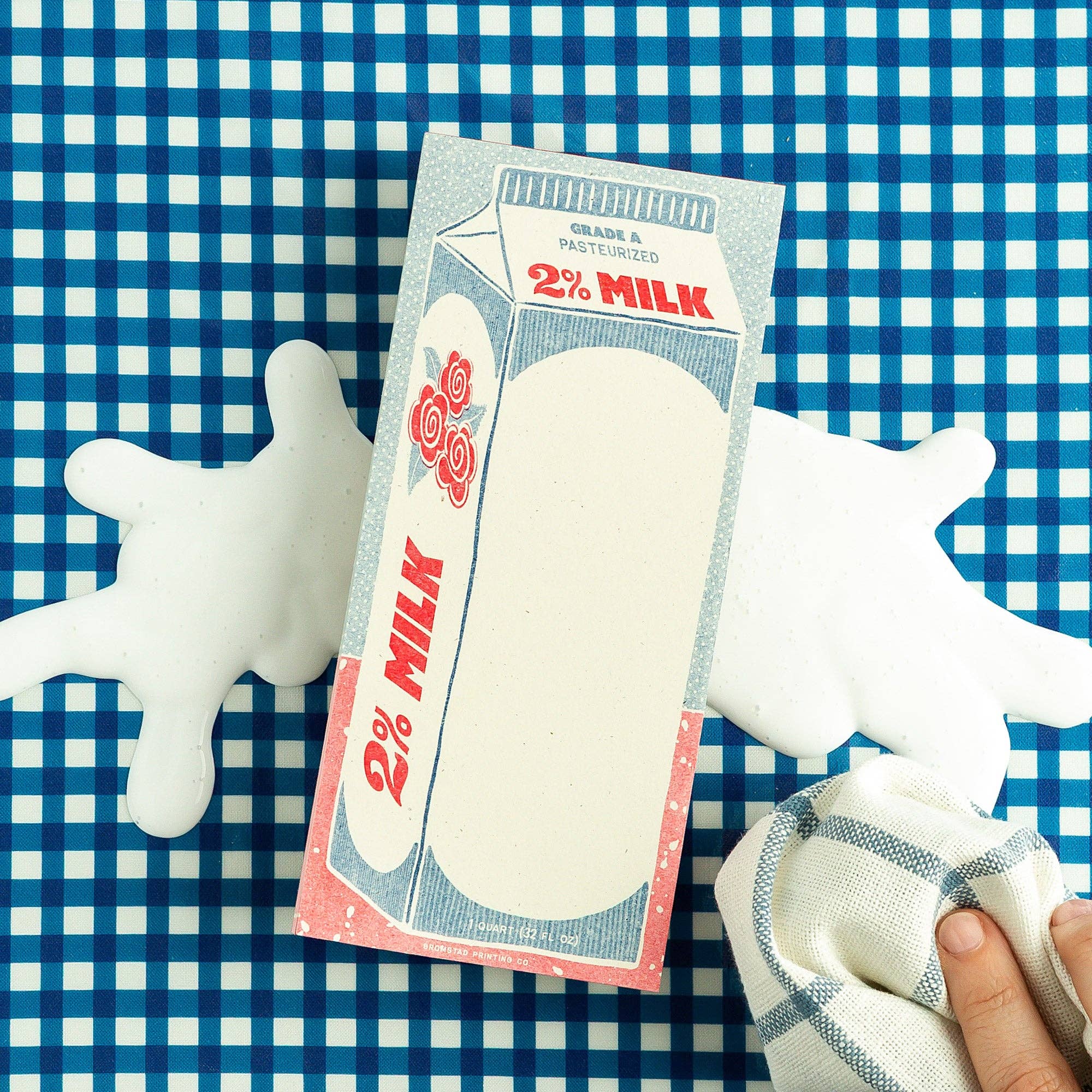 Milk carton notepad with a checkered tablecloth background
